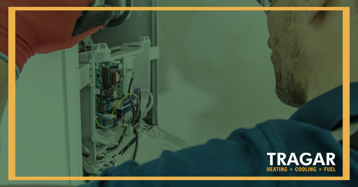 Technician checking panel and wiring.