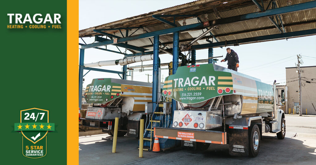 Two fuel delivery trucks under a canopy, with a person on top of one truck. Tragar branding visible. A 24/7 service badge is on the left side of the image.